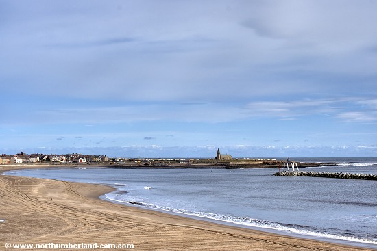 View across the bay and beach to the Church Point. The other beach at Newbiggin is beyond the point.