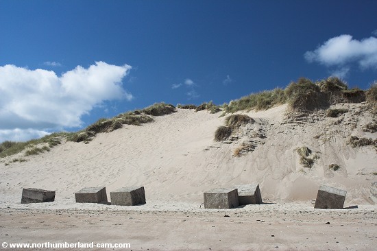 Large sand dunes and World War 2 anti-tank blocks at Warkworth Beach.