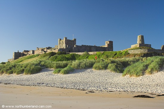 Early summer morning view of Bamburgh Beach and Castle.