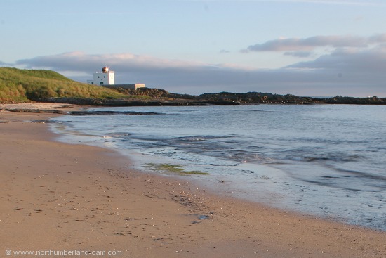Early summer morning view of Bamburgh Beach and Lighthouse.