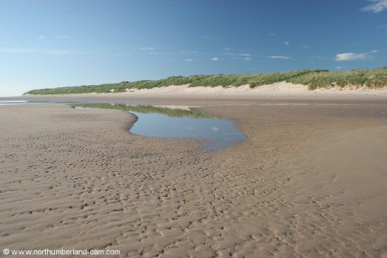 Early summer morning view of Bamburgh Beach.